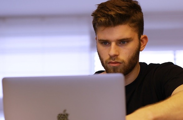 man looking on computer for benefits of BDSM